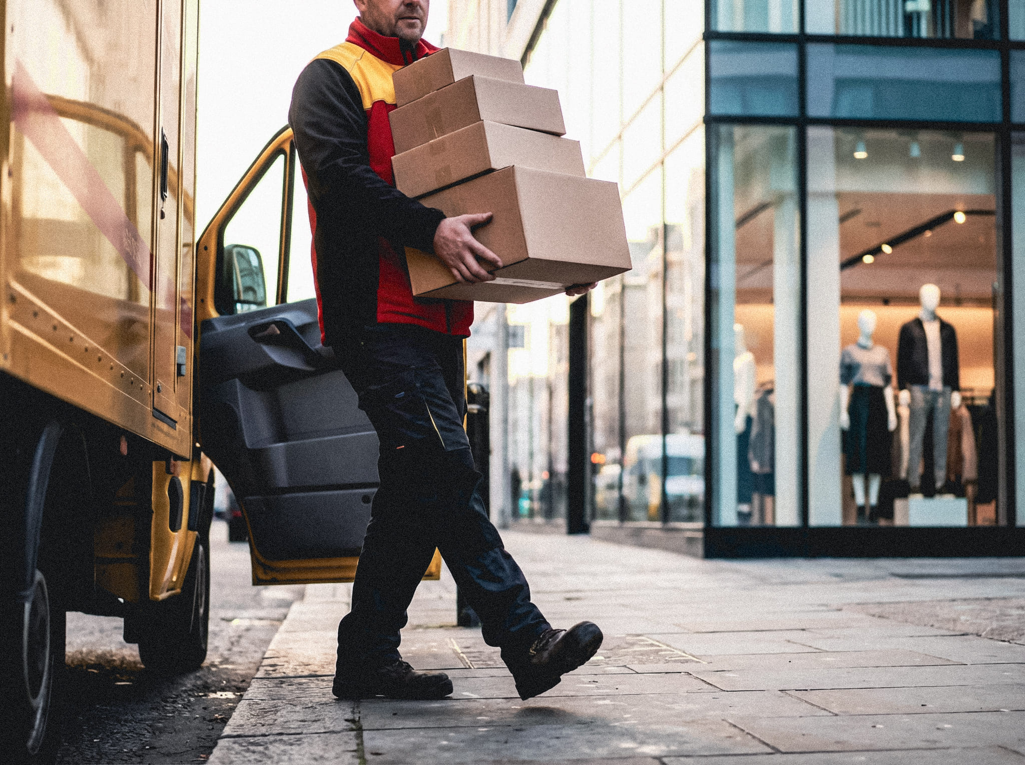 Firefly_Generate a photorealistic close-up image of a DHL delivery driver stepping out of a D 877404-2